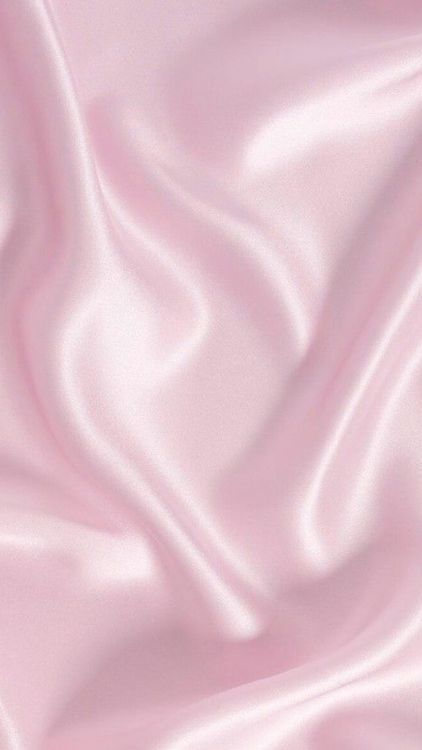 a pink silk background with very soft folds and smooth lines on the fabric in this image