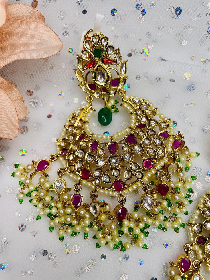 These gorgeous pair of earrings are made with 14k gold and is accented with high quality polki stones and pearls for the perfect statement look! The work is extremely beautiful with handcrafted stones and the colors are perfect to go with any outfit! Elegant Kundan Danglers For Celebration, Elegant Chandbali Earrings For Designer Wear, Elegant Chandbali Designer Earrings, Elegant Meenakari Earrings For Designer Wear, Elegant Designer Chandbali Earrings, Elegant Designer Chandbali Jhumkas, Designer Kundan Earrings For Diwali, Festive Jeweled Chandbali Pearl Earrings, Elegant Designer Chandbalis With Meenakari