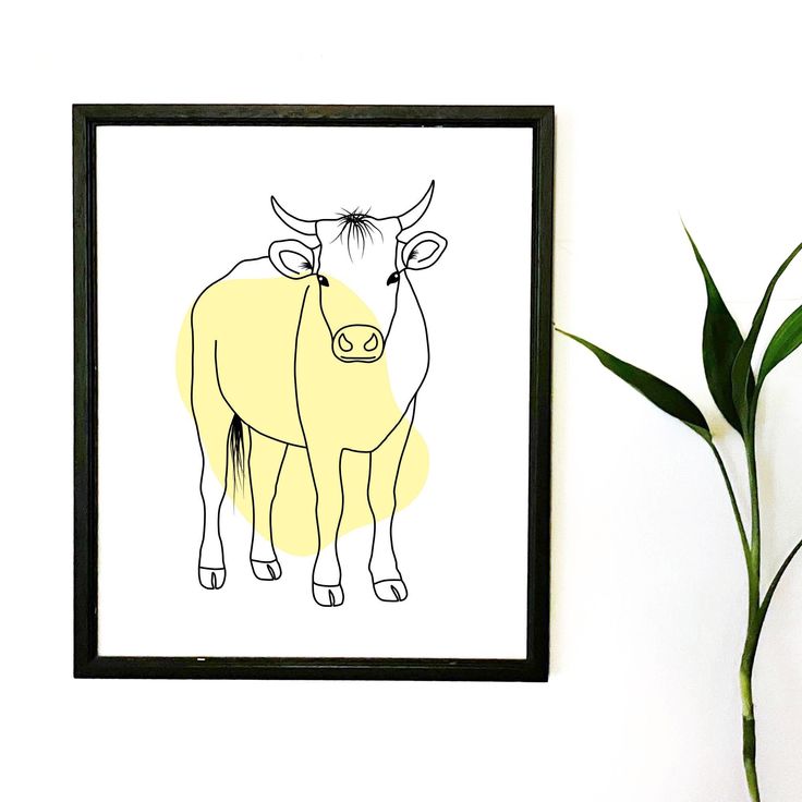 a drawing of two cows on a white wall next to a plant