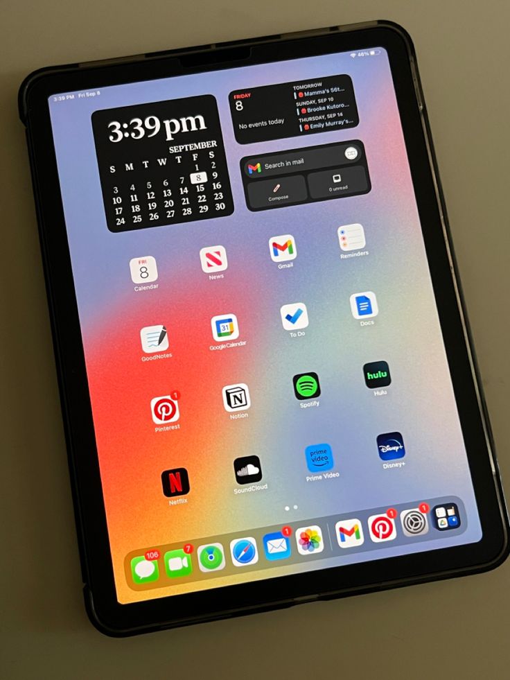 an ipad with the app icons displayed on it's display screen, sitting on a table