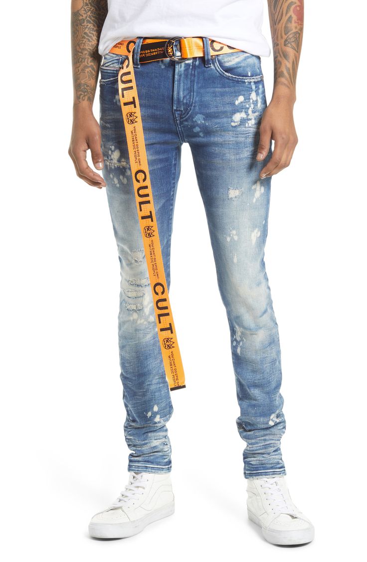 These super-skinny stretch-denim jeans are given a punk-rock update with a bleached wash covered in rips and paint splatters. A branded utility belt adds to the grunge aesthetic. 32" inseam; 11 1/2" leg opening; 10 1/2" front rise Zip fly with button closure Five-pocket style Removable utility belt 86% cotton, 10% spandex, 4% polyester Machine wash, line dry Imported Men's Clothing Distressed Slim Fit Cotton Jeans, Slim Fit Distressed Cotton Jeans, Distressed Slim Fit Jeans, Punk Style Distressed Blue Jeans, Blue Distressed Punk Jeans, Edgy Slim Fit Jeans For Streetwear, Fitted Punk Style Denim Jeans, Fitted Punk Jeans For Streetwear, Punk Style Fitted Jeans For Streetwear