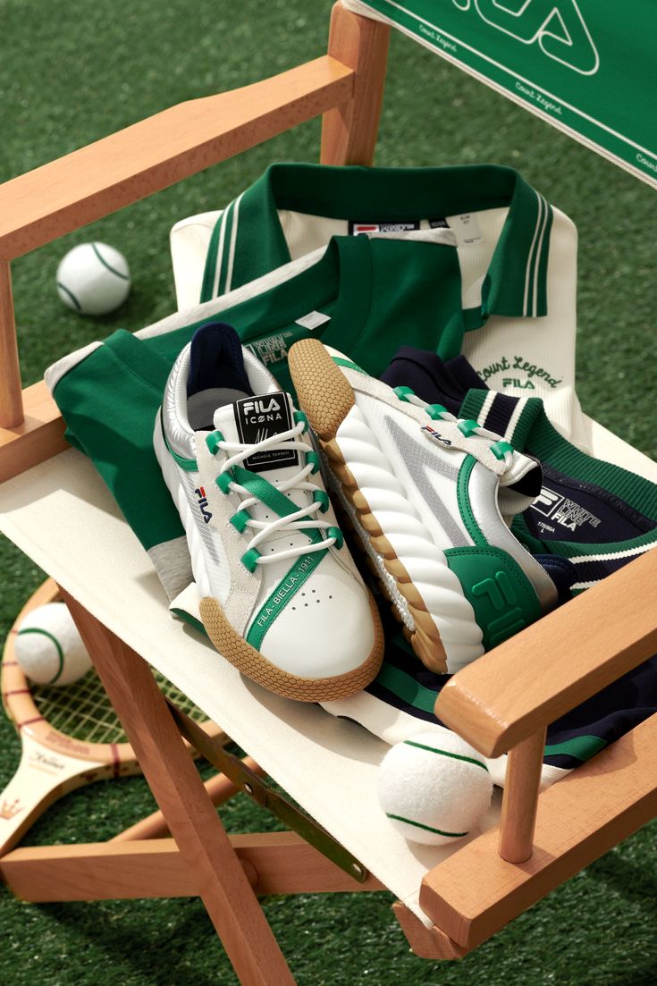 a tennis racket and shoes are sitting in a chair on the grass next to a ball