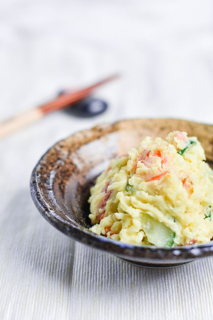 a bowl filled with mashed potatoes on top of a table