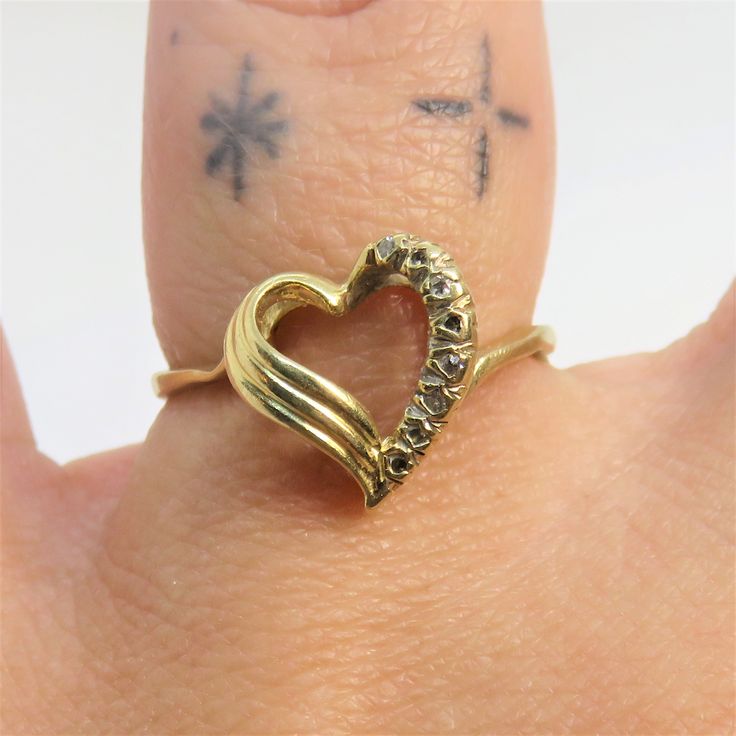 Vintage 14k yellow gold diamond heart ring US size 6 1/4 weight is 2.36-gram marked 14kt on the inner band band width at the back 1.9mm the front of the ring measures 11.1mm x 11mm (100 points =1 Carat) total carat weight for this ring is 8 points PLEASE BE ADVISED PHOTOS ARE CLOSE UPS TO SHOW DETAIL, PLEASE READ DESCRIPTION FOR A BETTER DESCRITION AND UNDERSTANDING OF ITEMS SIZE AND DIMENSIONS.This item is preloved and Vintage. This means it may have signs of wear and use and is offered as is. Diamond Heart Ring Hallmarked, Gold Diamond Ring Stamped 14k For Valentine's Day, 14k Stamped Diamond Ring For Valentine's Day, Stamped 14k Diamond Ring For Valentine's Day, 14k Heart Cut Diamond Ring For Valentine's Day, Valentine's Day Diamond Heart Ring, Hallmarked, Valentine's Day 14k Stamped Fine Jewelry Diamond Ring, Valentine's Day Diamond Heart Ring Hallmarked, Valentine's Day Hallmarked Diamond Heart Ring