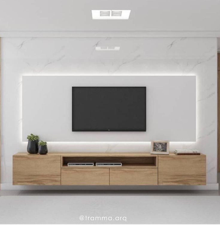 an entertainment center with a flat screen tv mounted on the wall