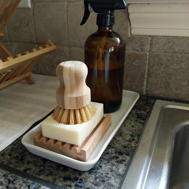 a soap dispenser sitting on top of a counter next to a sink