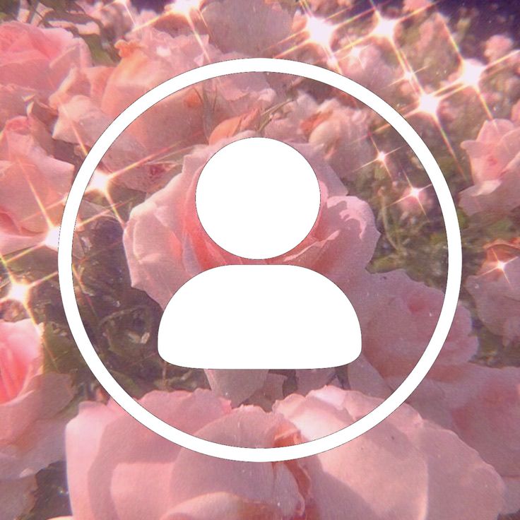 a white circle surrounded by pink flowers with a person's face in the center