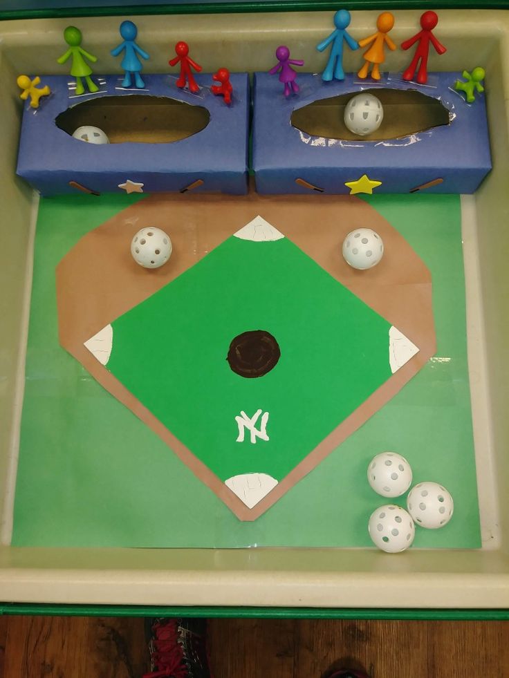 a baseball game with people standing on the base and in the outfield, ready to play