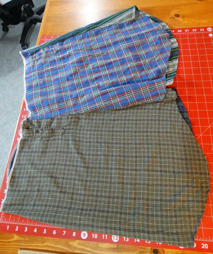 three pieces of clothing are laid out on a cutting board and ready to be sewn