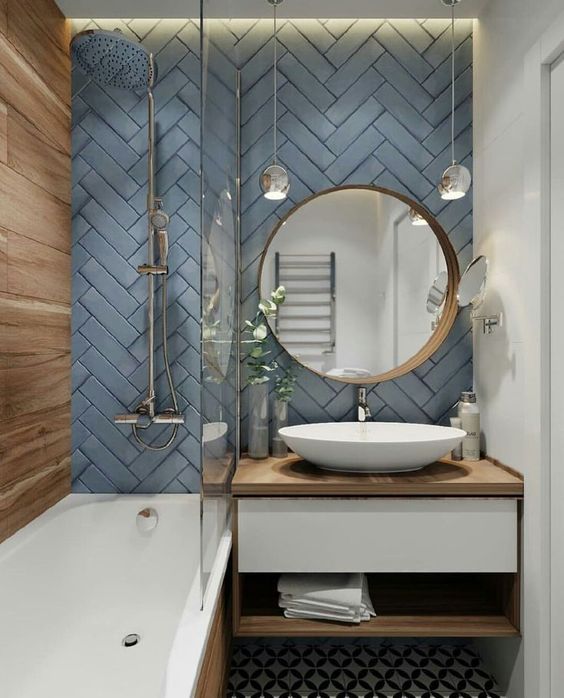 a bathroom with a sink, mirror and bathtub next to a wall mounted faucet