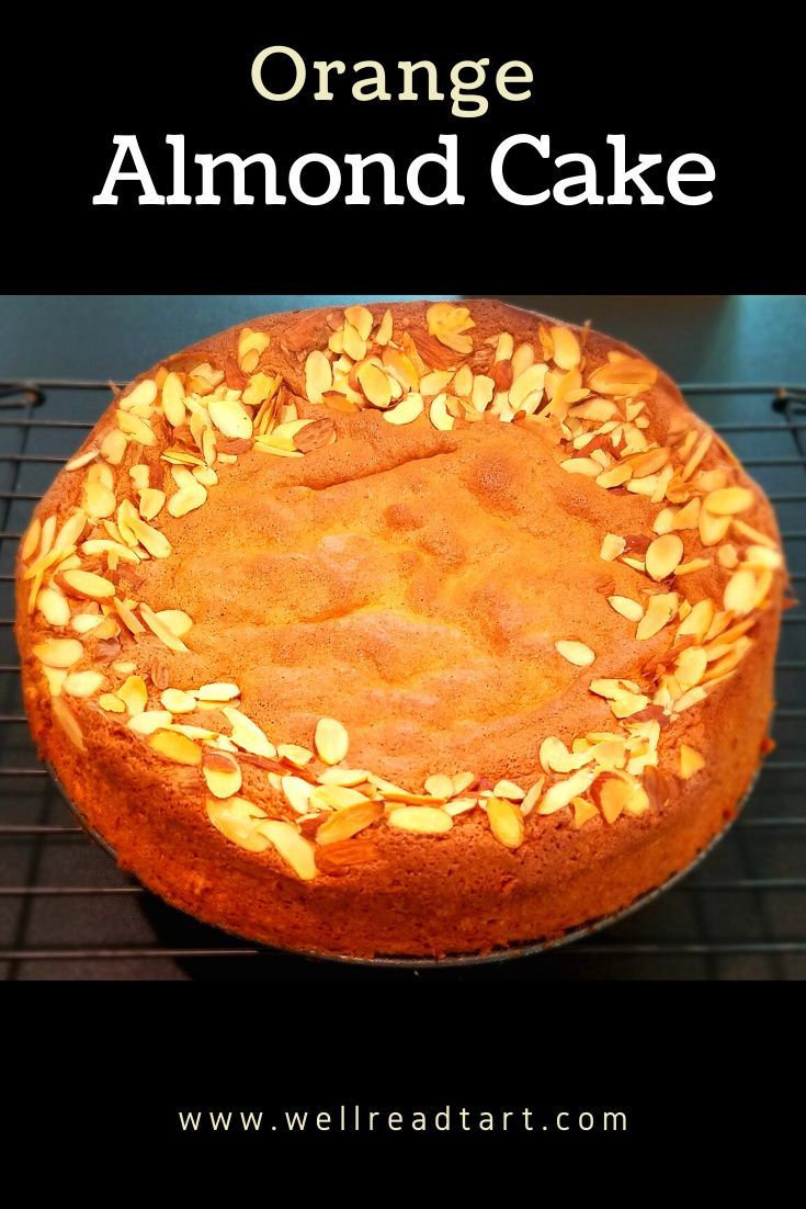 an orange cake with almonds on top is sitting on a cooling rack and has the words orange almond cake above it