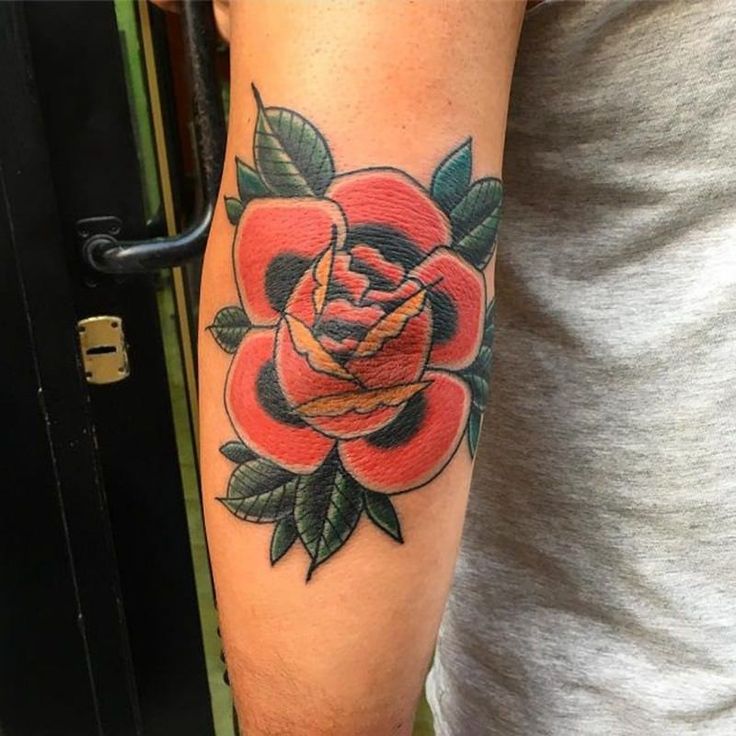 a man with a rose tattoo on his arm