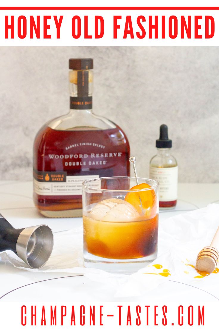 an old fashioned whiskey with orange peel in the foreground