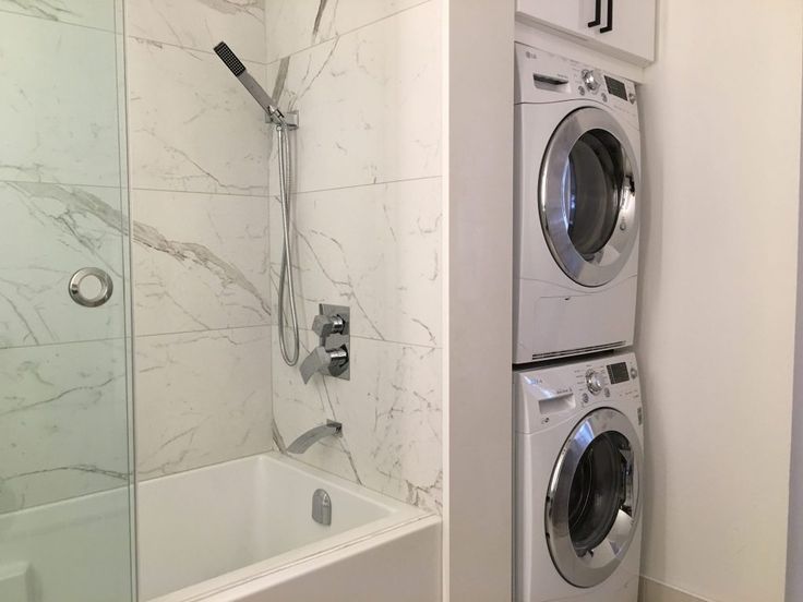 a washer and dryer in a bathroom next to each other