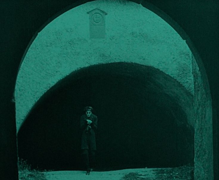 a man standing in the middle of a tunnel