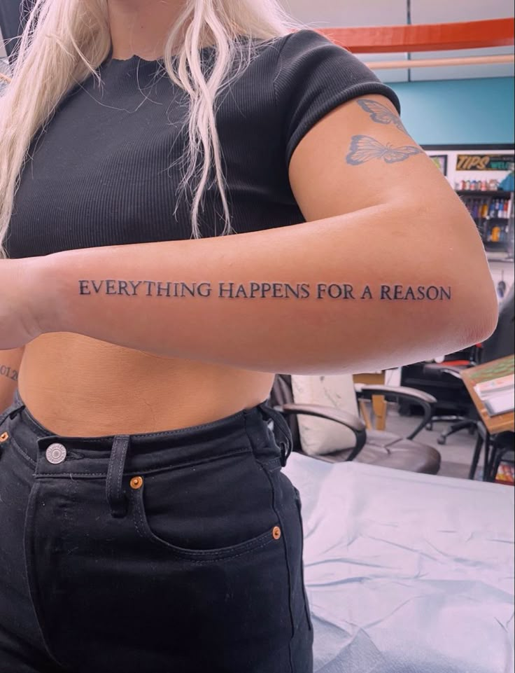 a woman with a tattoo on her arm that says everything happens for a reason,