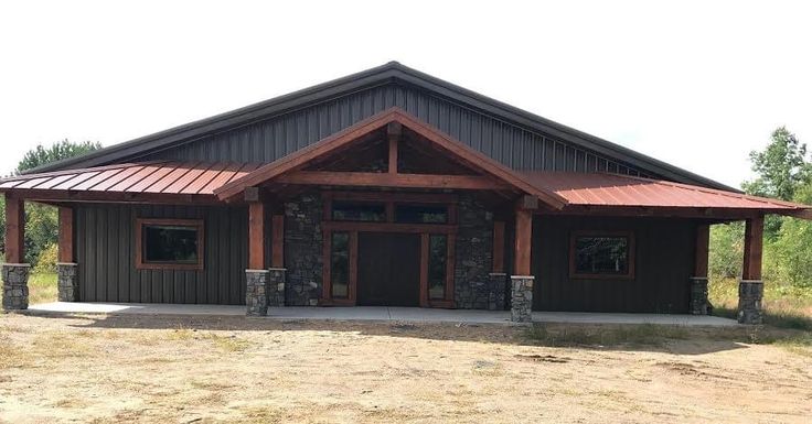 a large brown building sitting on top of a dirt field