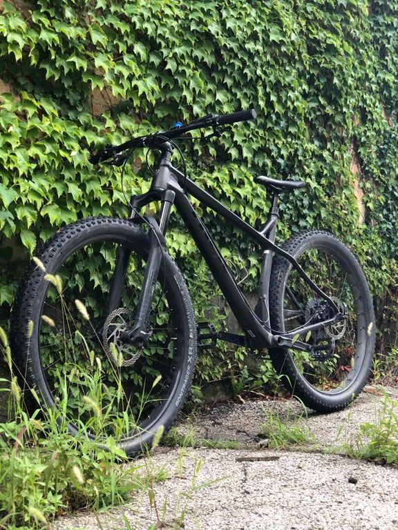 a black bike parked in front of a green wall