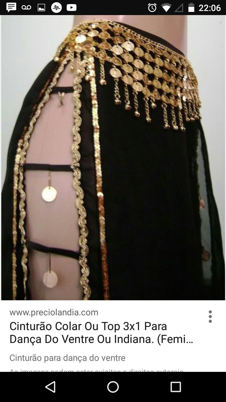 the back of a woman's black dress with gold chains and beads on it