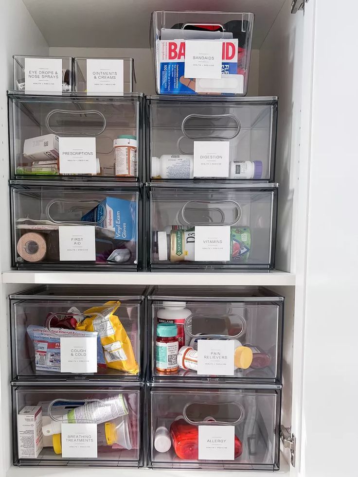 an organized pantry with plastic bins and labels