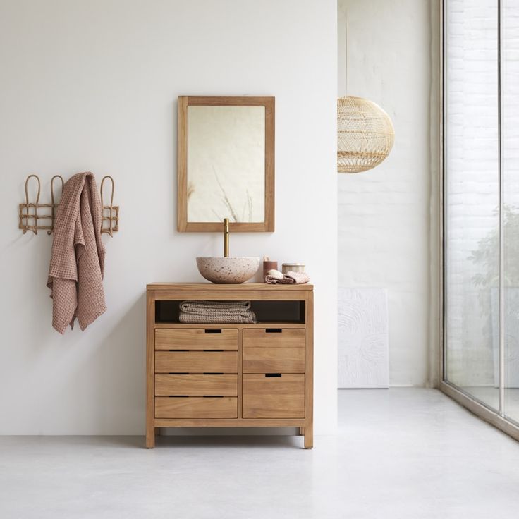 a bathroom with a sink, mirror and towel rack