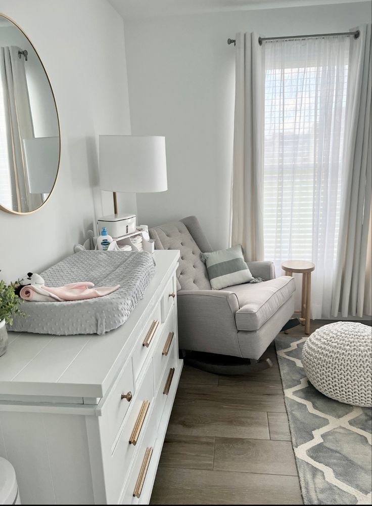 a baby's crib in the corner of a room with a large mirror