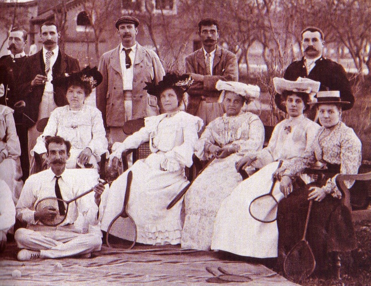 an old black and white photo of people with tennis rackets