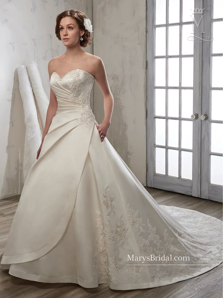 a woman in a wedding dress posing for the camera