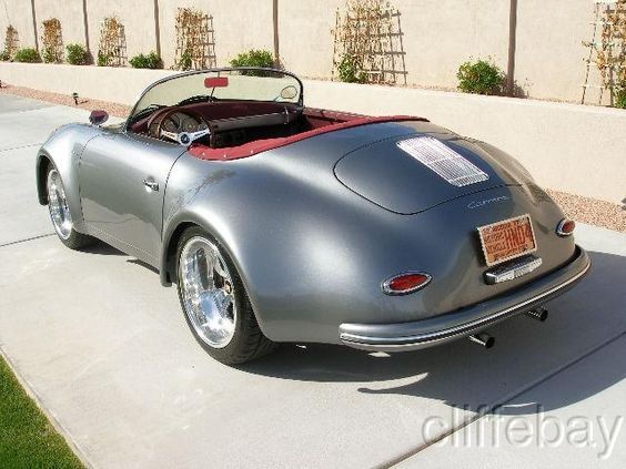 a gray sports car parked in front of a building