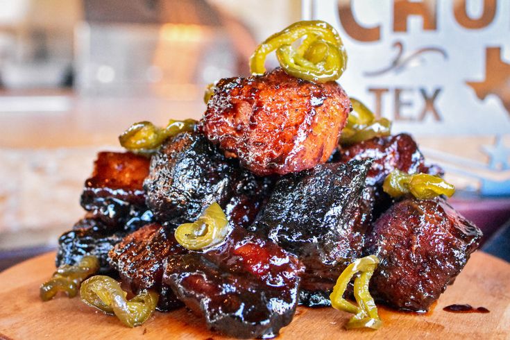 a pile of food sitting on top of a wooden cutting board