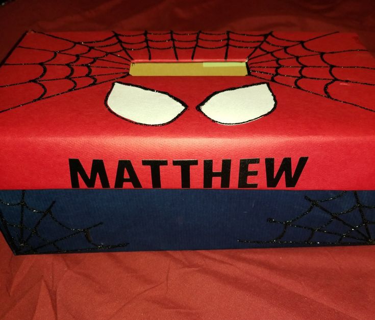 a red box with a spiderman face on it that says,'mathew '