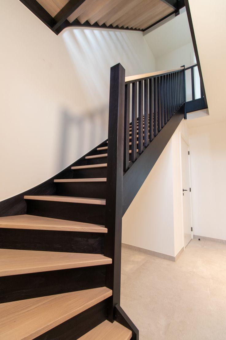 a black and white staircase in an empty room