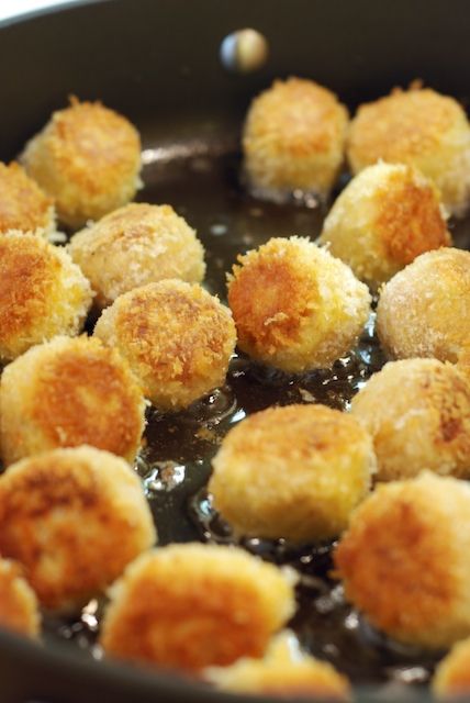 some fried food is cooking in a pan on the stove top and ready to be eaten