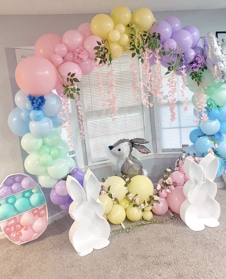 a room decorated with balloons and bunny ears