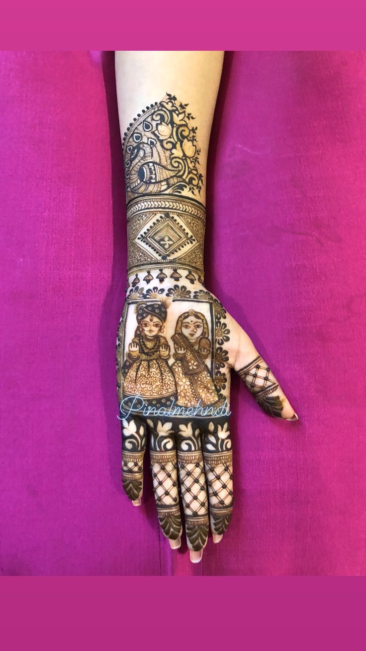 a woman's hand with hennap on it and some tattoos on the palm