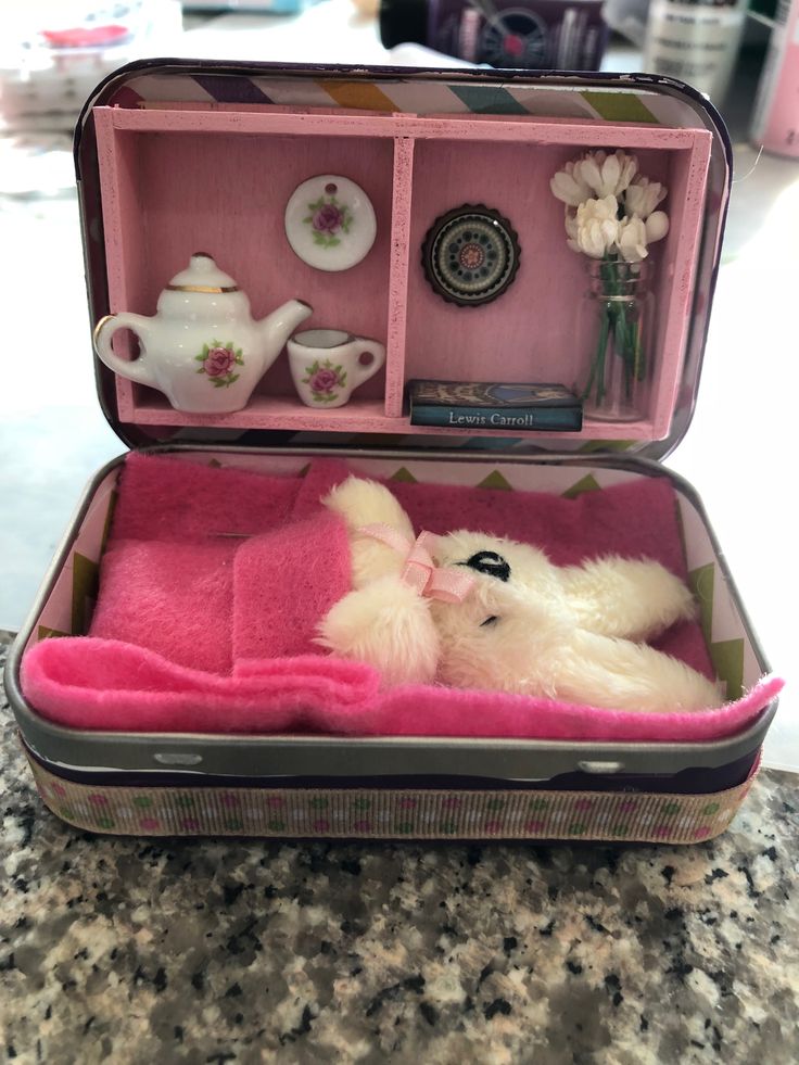 an open suitcase filled with stuffed animals on top of a table