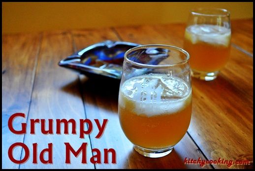 two glasses filled with beer sitting on top of a wooden table