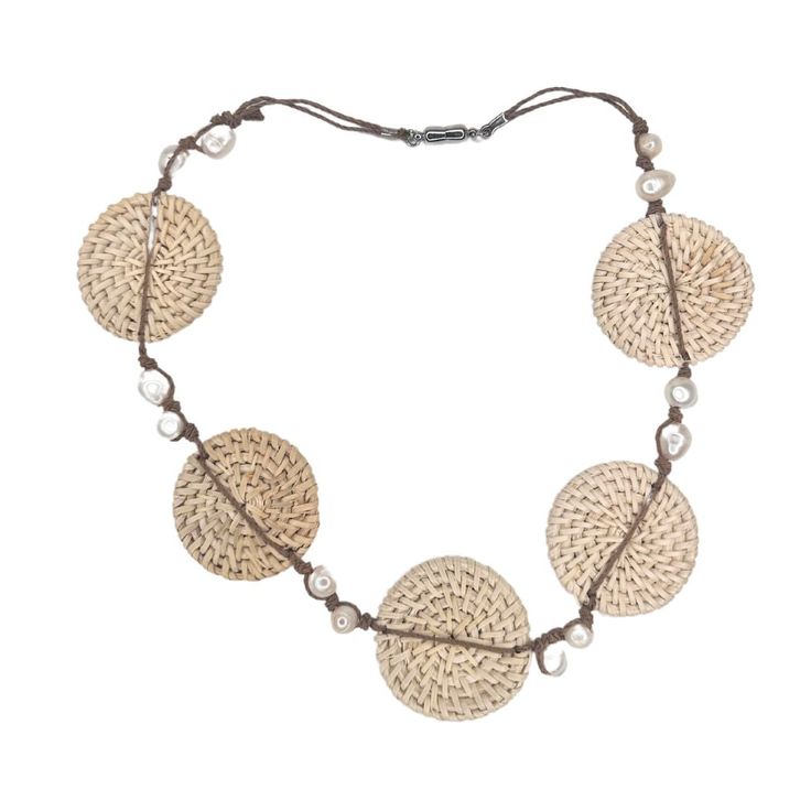 This lightweight statement necklace elegantly combines the luminous beauty of freshwater pearls with the earthy beauty of hand woven rattan. A double strand of waxed cotton knots 12 pearls in place. A piece of organic luxury that will elevate any ensemble. The magnetic closure makes it a snap to put on and remove. The rattan circles are about 1.75". The length of the necklace open is 21". If you would like a shorter version, just leave a note. Add this to your vacation wardrobe today! Adjustable Multi-strand Hand Wrapped Necklace, Adjustable Round Nature-inspired Necklace, Adjustable Nature-inspired Necklace, Nature-inspired Adjustable Round Necklace, Adjustable Bohemian Necklace With Silk Cord, Artisan Adjustable Natural Necklace, Artisan Adjustable Natural Necklaces, Artisan Adjustable Natural Color Necklaces, Bohemian Necklace With Adjustable Silk Cord