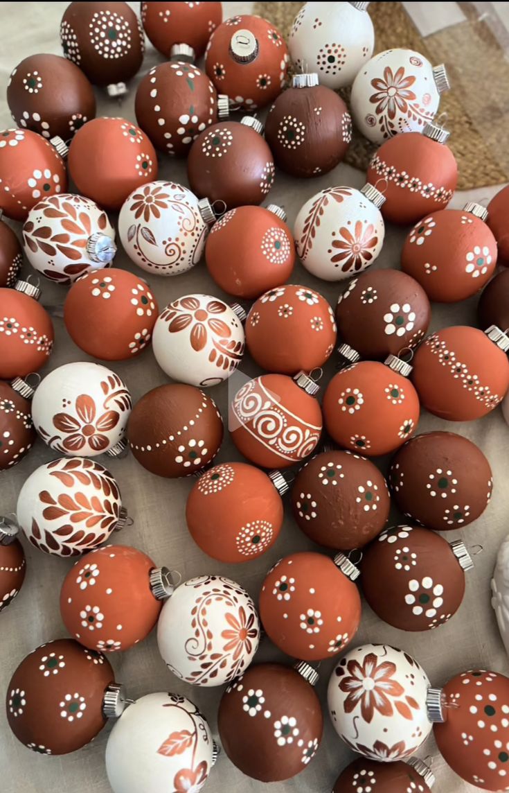 some brown and white decorated eggs on a table