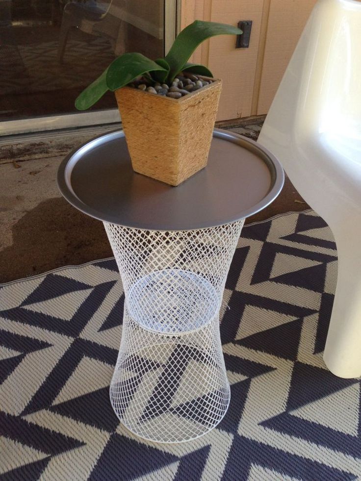 a potted plant sitting on top of a metal table