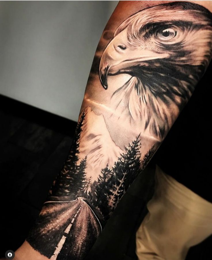 an eagle with trees on it's arm