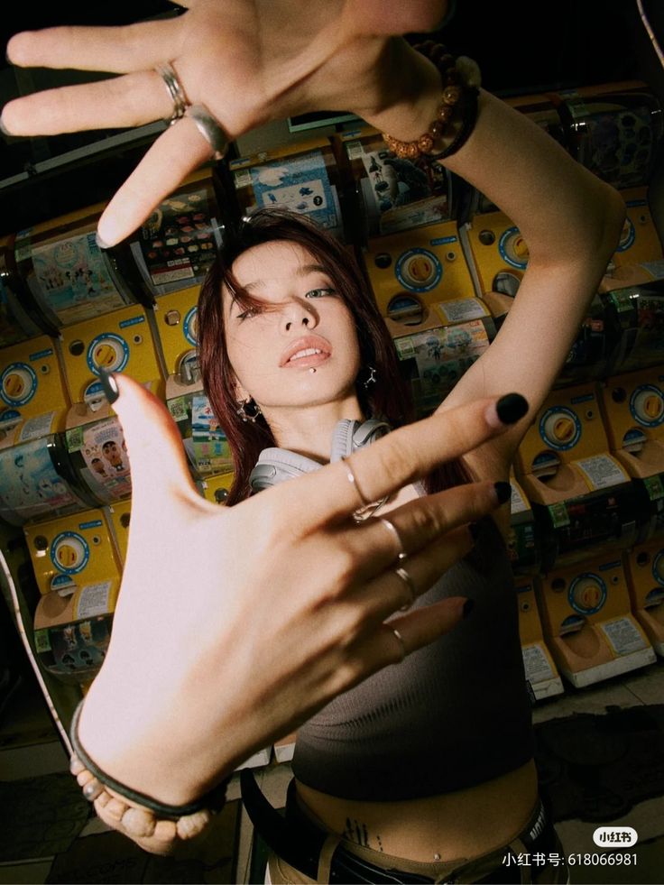 a woman holding her hands up in front of stacks of boxes with their fingers on them