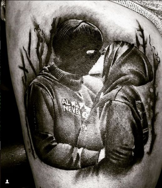 a black and white photo of a man's thigh with the image of a baseball player on it