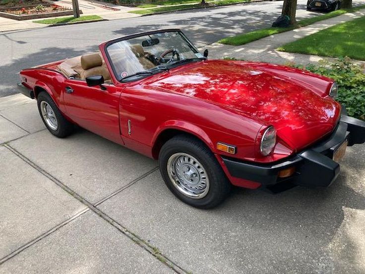 a red sports car parked on the side of the road