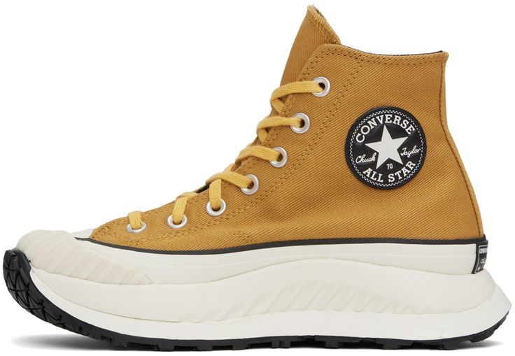 High-top cotton twill sneakers in yellow. Faux-leather logo patch at inner side. · Round textured rubber cap toe · Lace-up closure · Canvas lining · Padded CX foam footbed · Foam rubber platform midsole · Treaded rubber outsole · Platform: H1.5 in Supplier color: Burnt honey/Thriftshop yellow Chuck 70, Converse Sneakers, Black Friday Deals, Mens Sportswear, Sneaker Collection, Personal Shopping, Sneakers For Sale, Patch Logo, Cotton Twill