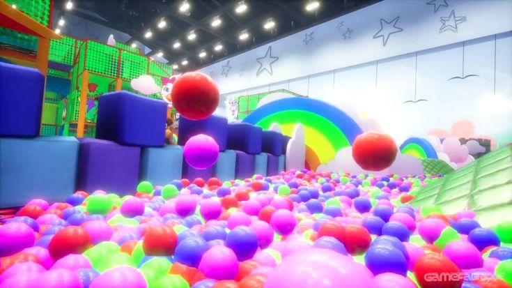 an inflatable ball pit with lots of balls on the floor and colorful walls