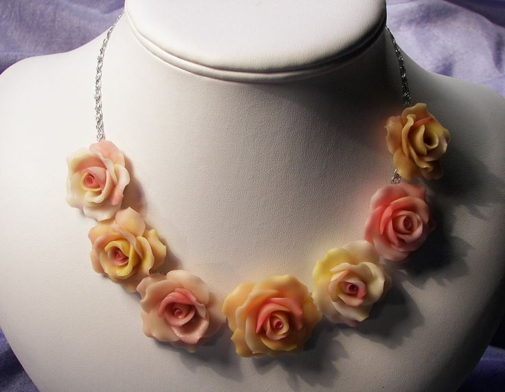 That rose necklace is handmade entirely with polymer clay. They are two tone natural looking yellow/orange and creamy/peachy roses in graduate sizes from medium( 0.5 " to 1" ) to large. The roses are attached to a silver chain app, 14" with extra 2" extension. These are hand sculptured petal by petal from Polymer Clay ( is very light weight modeling synthetic material not like regular clay) is a very unique One of a Kind piece and also can be made in any other colors, upon your request. Matching earrings also available,  just check the listed -pink rose earrings -and add note as matching color for this specific necklace. Pink Flower-shaped Necklaces With Roses, Adjustable Pink Necklace With Rose Design, Adjustable Pink Polymer Clay Necklace, Hand Sculpture, Chocker Necklace, Rose Necklace, Rose Earrings, Yellow Orange, Matching Earrings