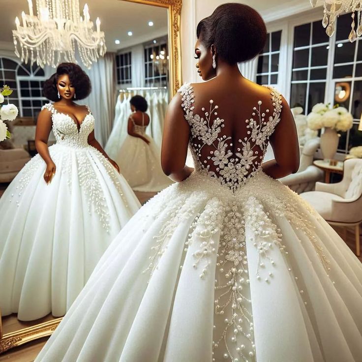 a woman in a white wedding dress looking at herself in the mirror with her reflection