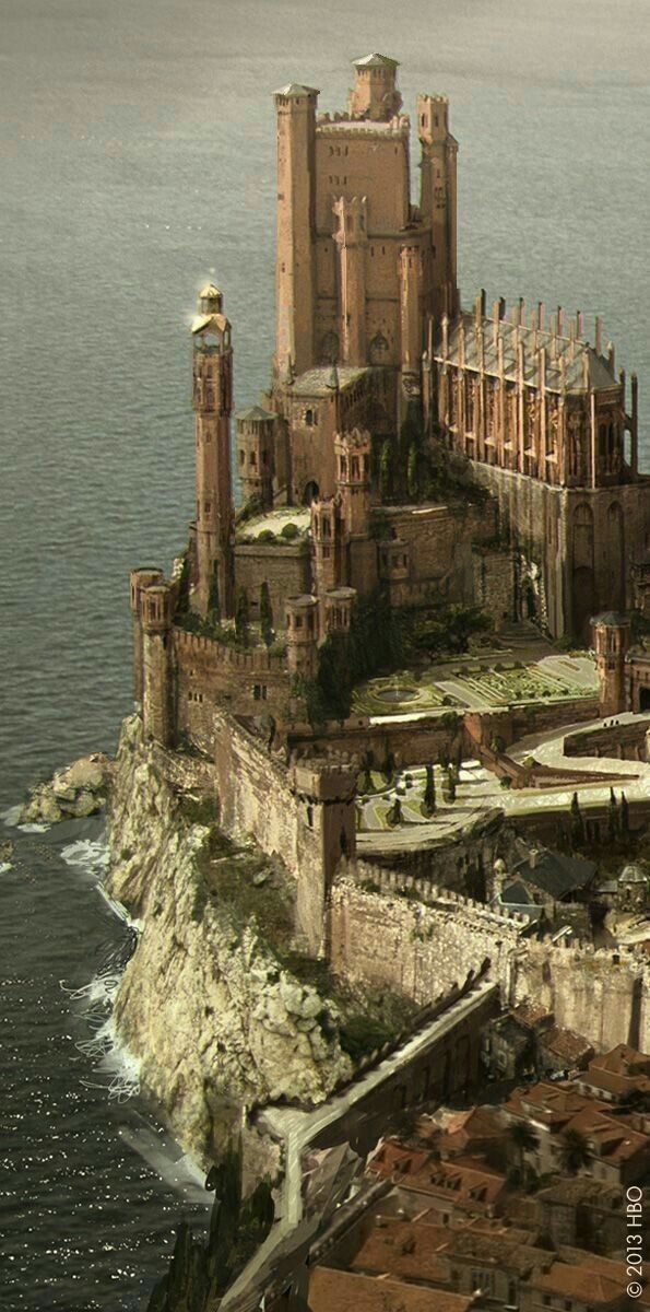 an old castle on top of a cliff by the ocean