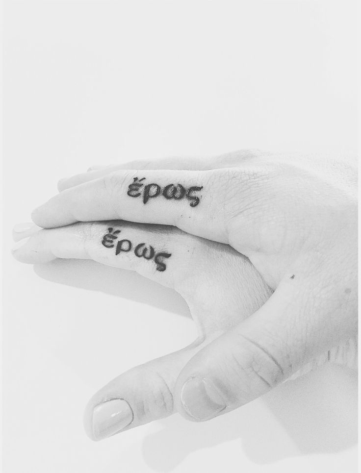 two hands with tattoos on their fingers and the words eposs ews written in black ink